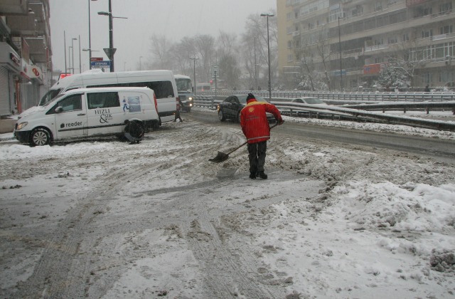 Gas station worker clearing entry to the station for cars to be able to get gas