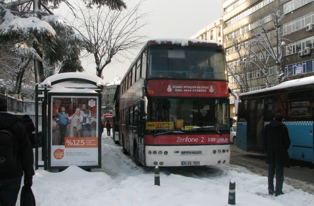 A bus waiting for passengers in snow in Istanbul.