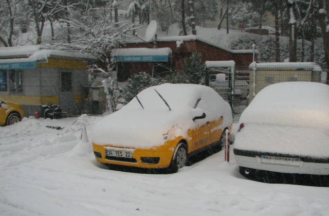 Taksi protecting windshields from frost. Snow in Istanbul.